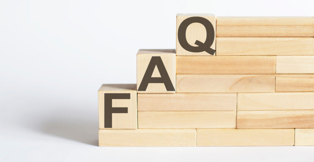 Wooden blocks arranged like stairs, with large black letters "F", "A", and "Q" on three ascending steps, representing the abbreviation for Frequently Asked Questions. The background is plain white.